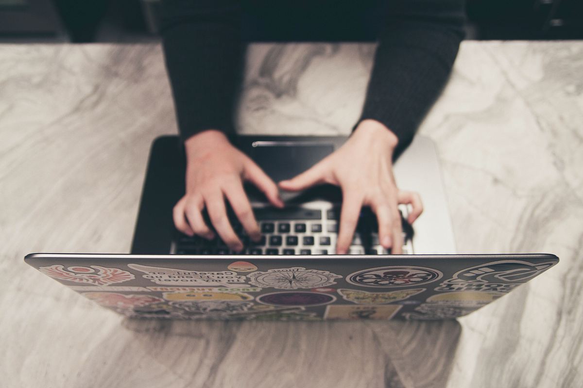 person typing on MacBook